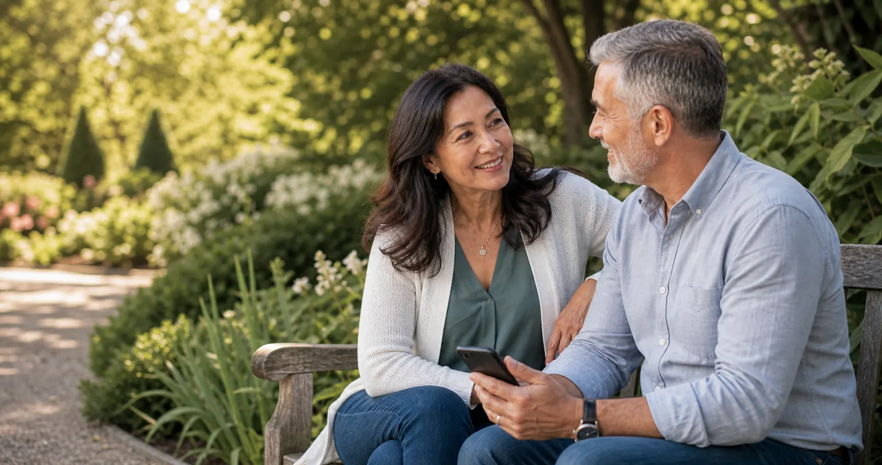 A smiling couple over 50 sharing a quiet moment outdoors